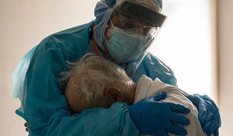 A doctor hugged a distraught elderly coronavirus patient on Thanksgiving, after warning the public America is headed for its ‘darkest days’ over Christmas